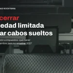 Oficina diáfana vacía con puestos de trabajo sin personas, junto al titular sobre cómo cerrar una sociedad limitada